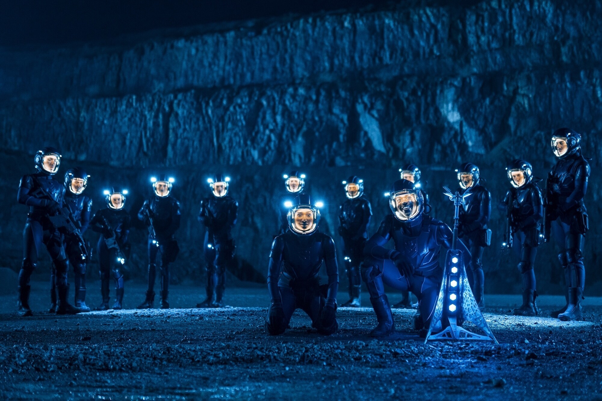 The Doctor and Belinda under suspicion of the soldiers are held at gun point on the ground of a baren planet.