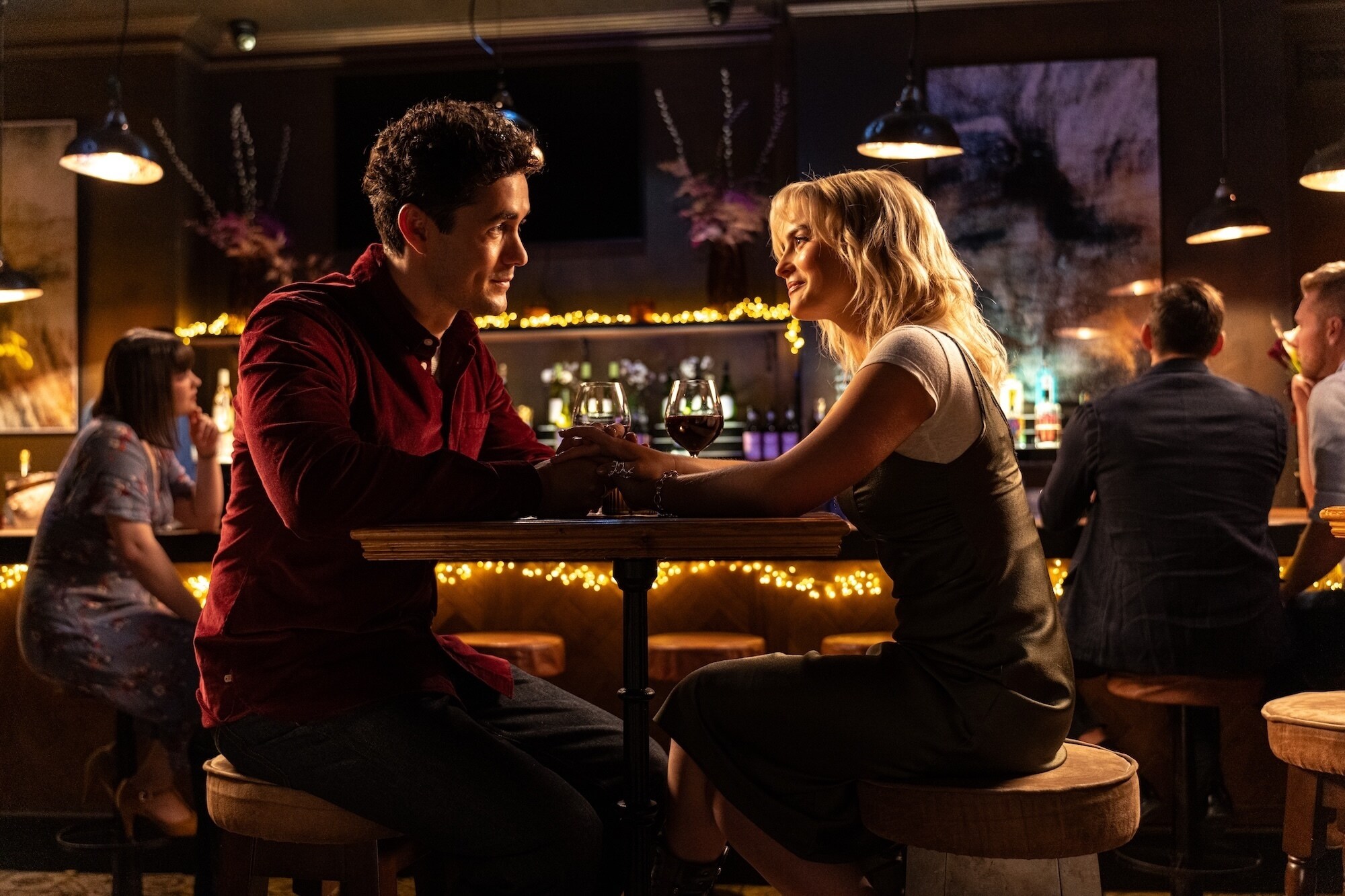 Ruby and Conrad on a date in a restaurant.