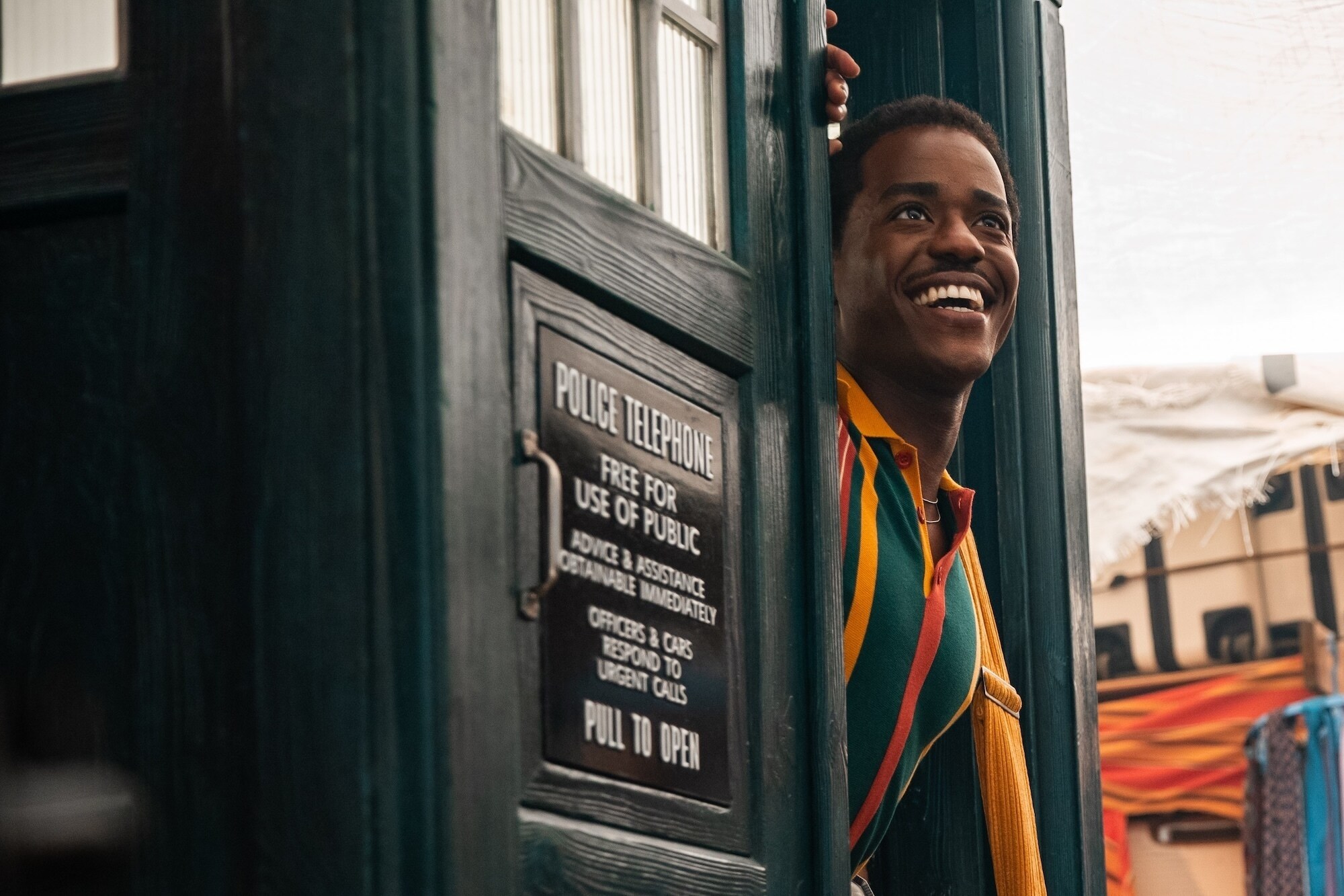 The Doctor (Ncuti Gatwa) stepping out of the Tardis and into the streets of Lagos Nigeria the setting for this episode.